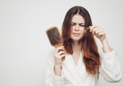 woman-removes-curls-hair-from-comb-loss-health-problems-model_163305-73681