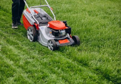 man-cutting-grass-with-lawn-mover-back-yard
